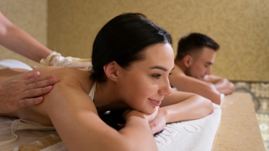 Couple enjoying a relaxing massage in a tranquil spa setting, promoting wellness.